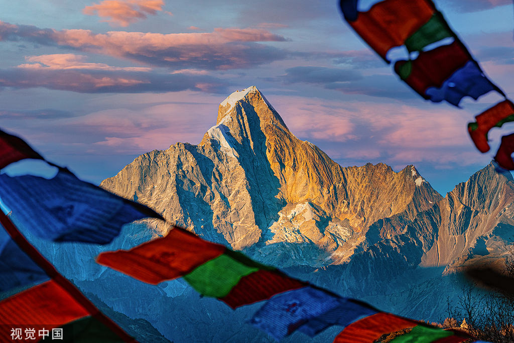 Prayer flags and a gold-lit peak